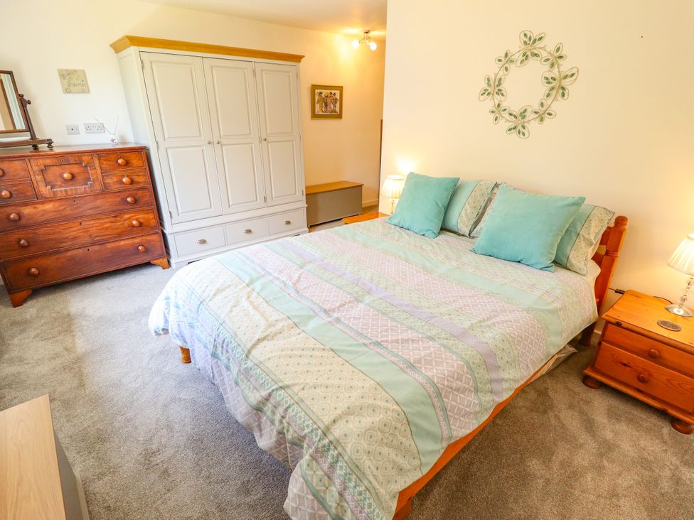 A bedroom with a bed and wardrobe at 80 Pentney Lakes in Pentney near King's Lynn