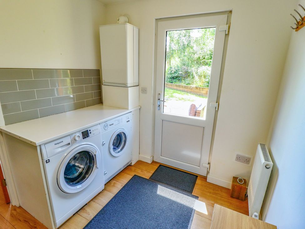 A utility room with a washing machine and dryer at 80 Pentney Lakes, Pentney near King's Lynn