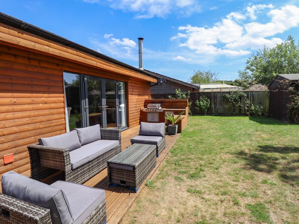 A garden with seating area and grill at 80 Pentney Lakes in Pentney near King's Lynn