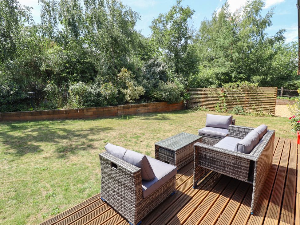 A garden with a sofa set and table at 80 Pentney Lakes Pentney near King's Lynn
