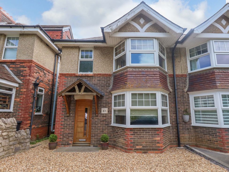 A house exterior with a front door and windows at Little Gem in Weymouth