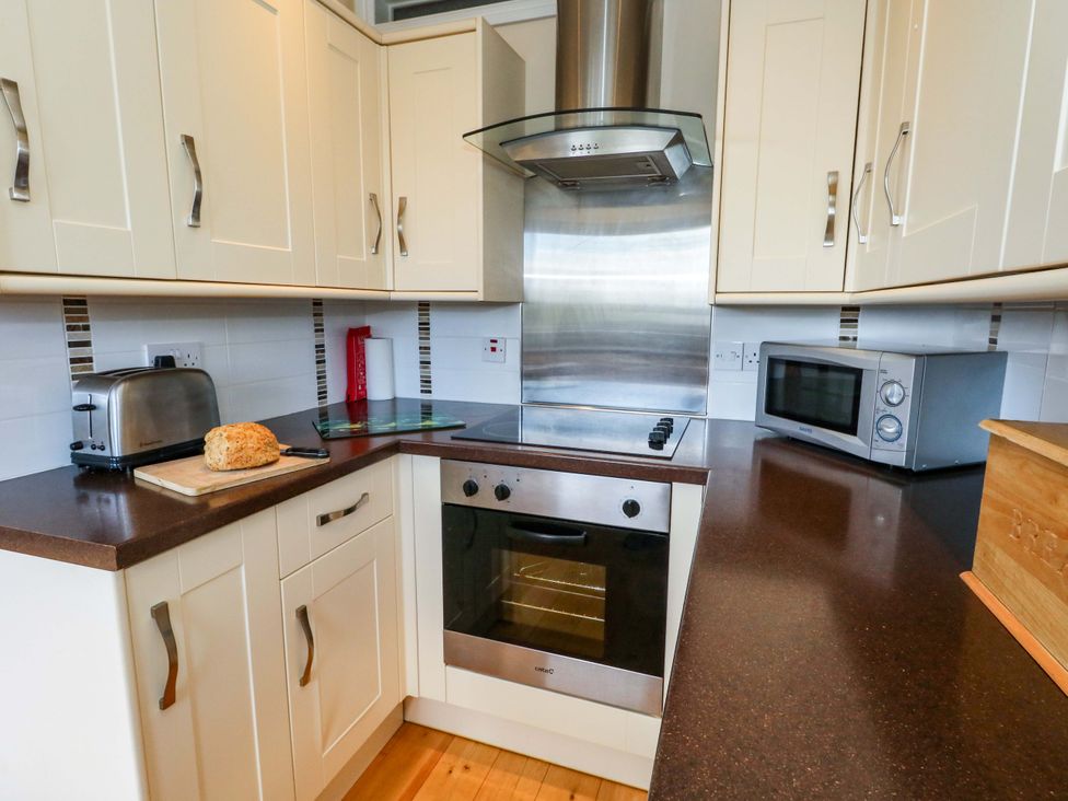A kitchen with appliances and countertop at Little Gem in Weymouth