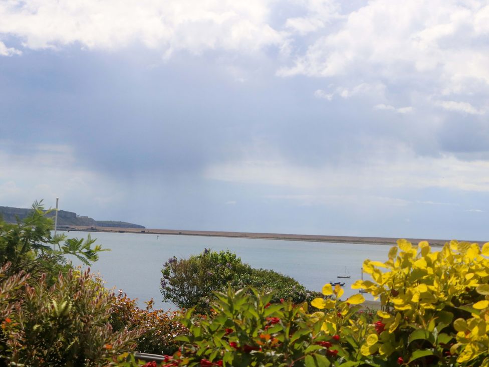 A view of the sea with boats and plants at Little Gem in Weymouth