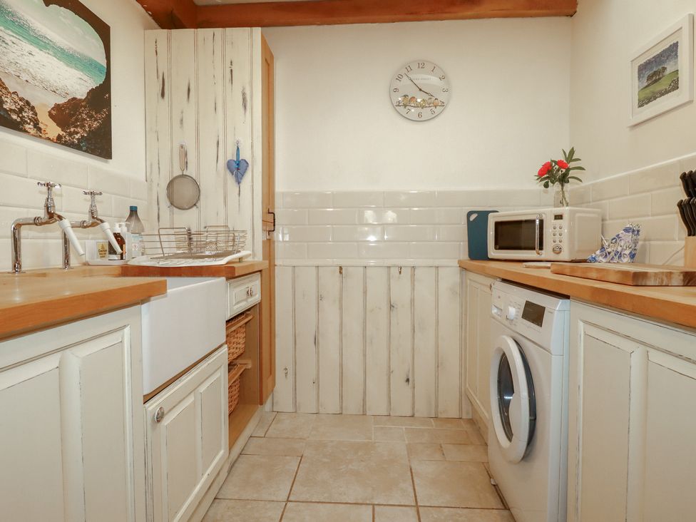 A kitchen with a sink and dishwasher at Cider Cottage