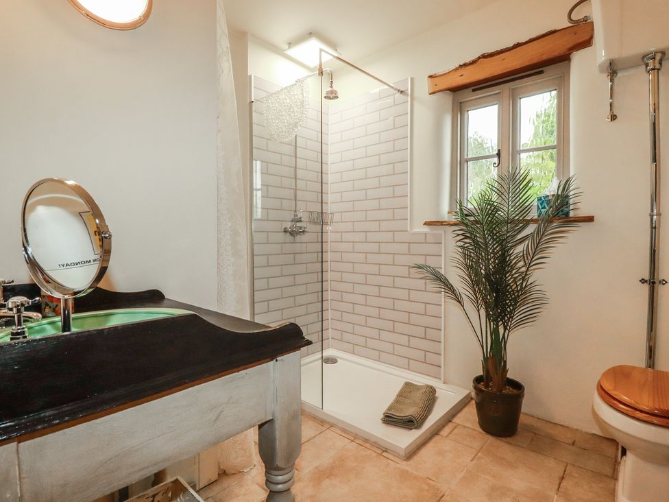 A bathroom with a shower and sink at Cider Cottage