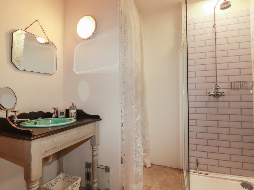 A bathroom with a wash basin and shower at Cider Cottage