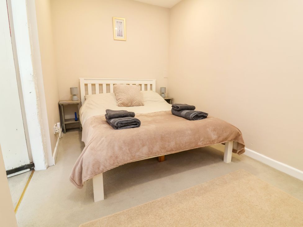 A bedroom with a bed and bedside table at Coach House Highampton near Black Torrington