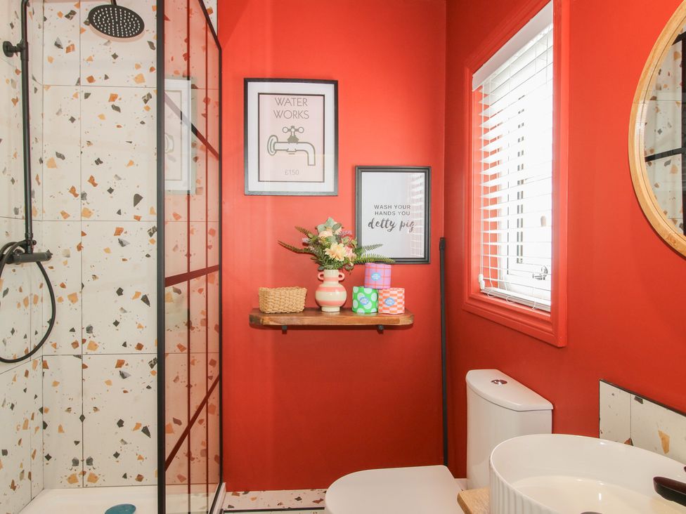 A bathroom with a shower and sink at The Dinky Dairy in Treflach near Trefonen