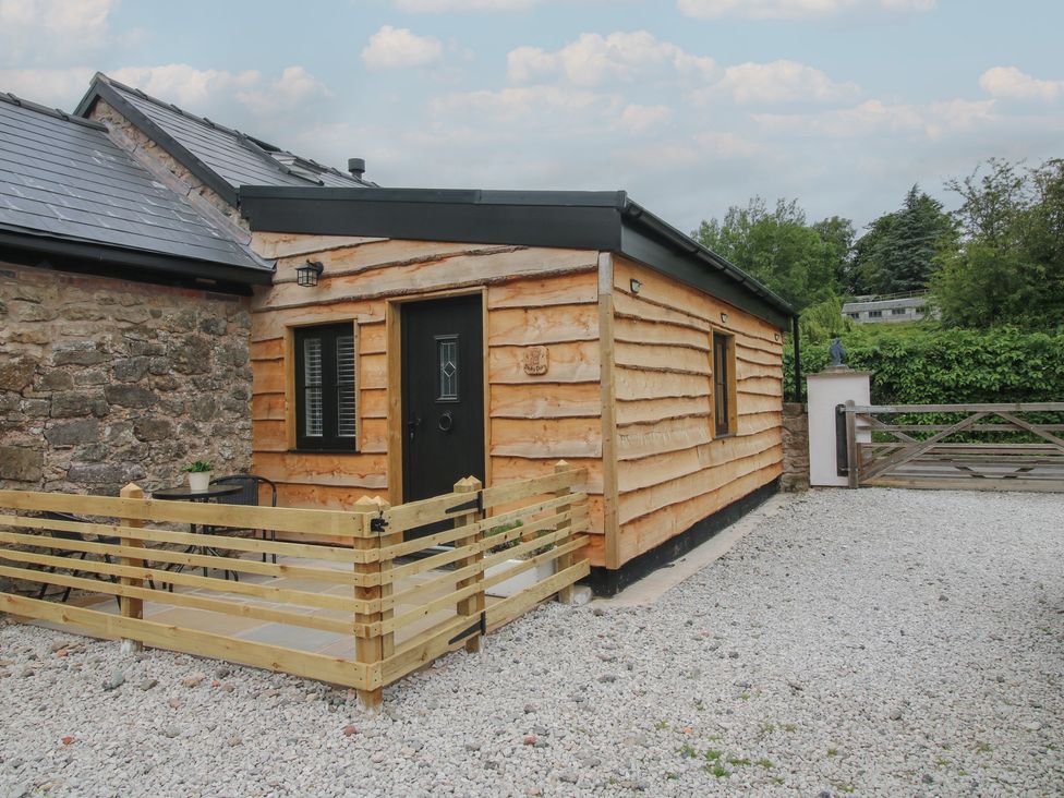 An exterior view of a wooden building at The Dinky Dairy Treflach near Trefonen