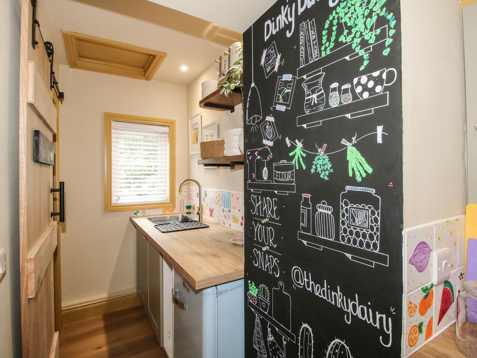 A kitchen with a sink and countertop at The Dinky Dairy Treflach near Trefonen