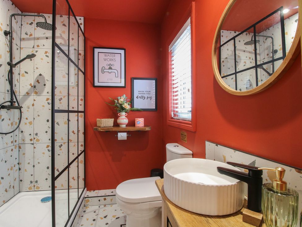 A bathroom with a shower and toilet at The Dinky Dairy in Treflach near Trefonen