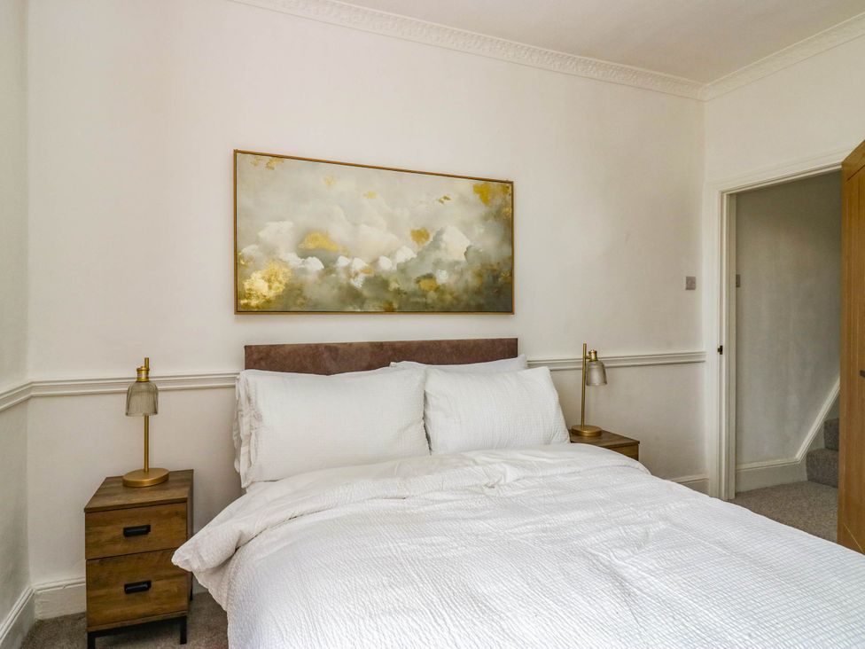 A bedroom with a bed and bedside tables at 24 Harrington Road in Workington