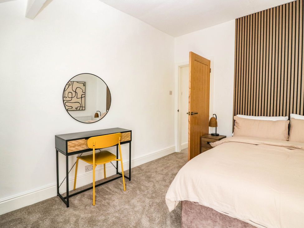 A bedroom with a bed and desk at 24 Harrington Road Workington