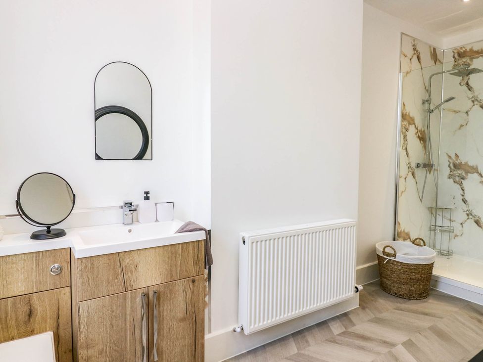 A bathroom with a shower and sink at 24 Harrington Road Workington
