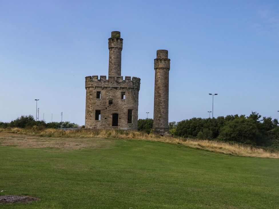 A tower structure in a grassy area at 24 Harrington Road, Workington