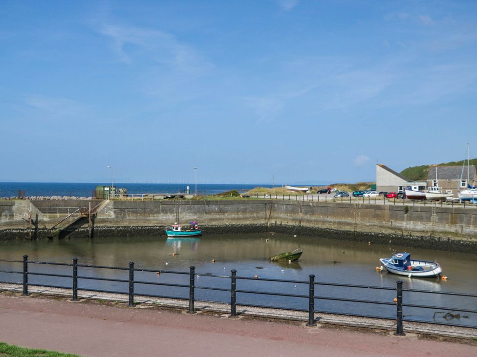 A harbor with boats and water at 24 Harrington Road, Workington