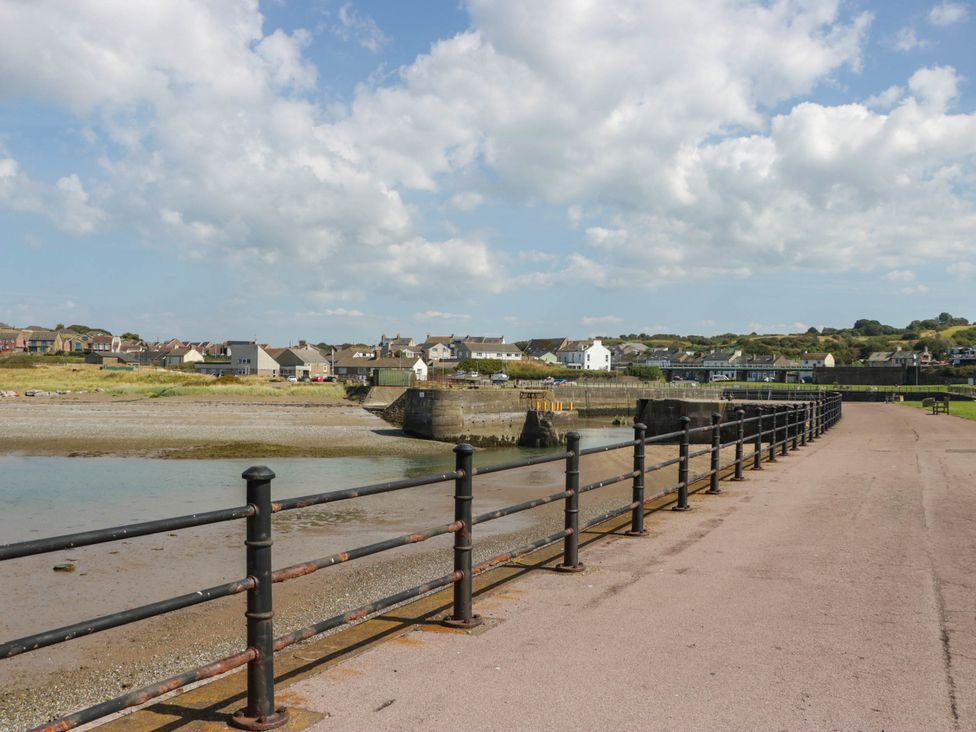 A view of a path by the water with houses in the background at 24 Harrington Road, Workington
