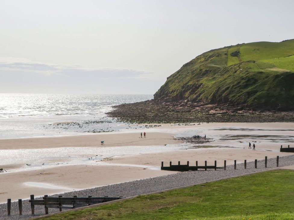 A beach with people walking at 24 Harrington Road in Workington