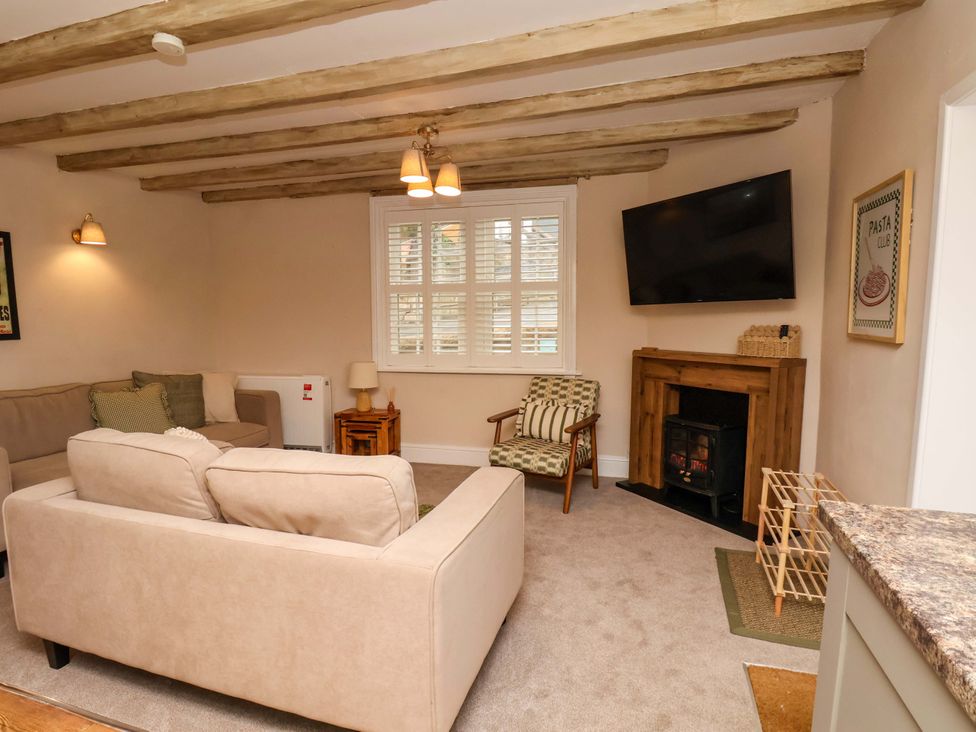 A living room with a sofa and fireplace at Wick Cottage in Whitby