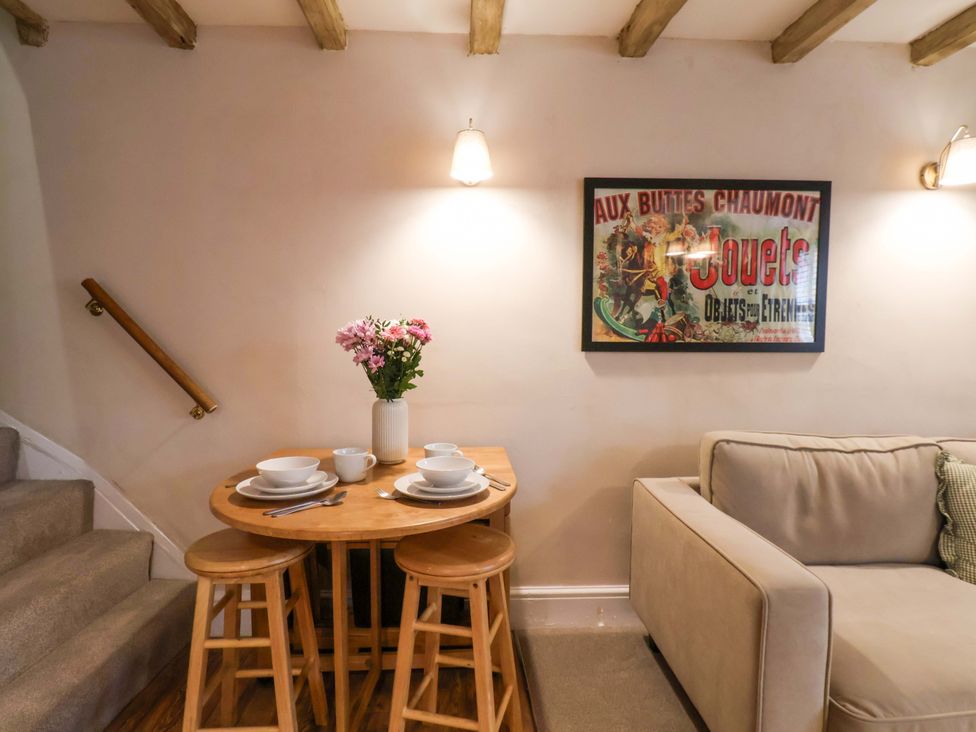 A dining area with a table set and a sofa at Wick Cottage in Whitby