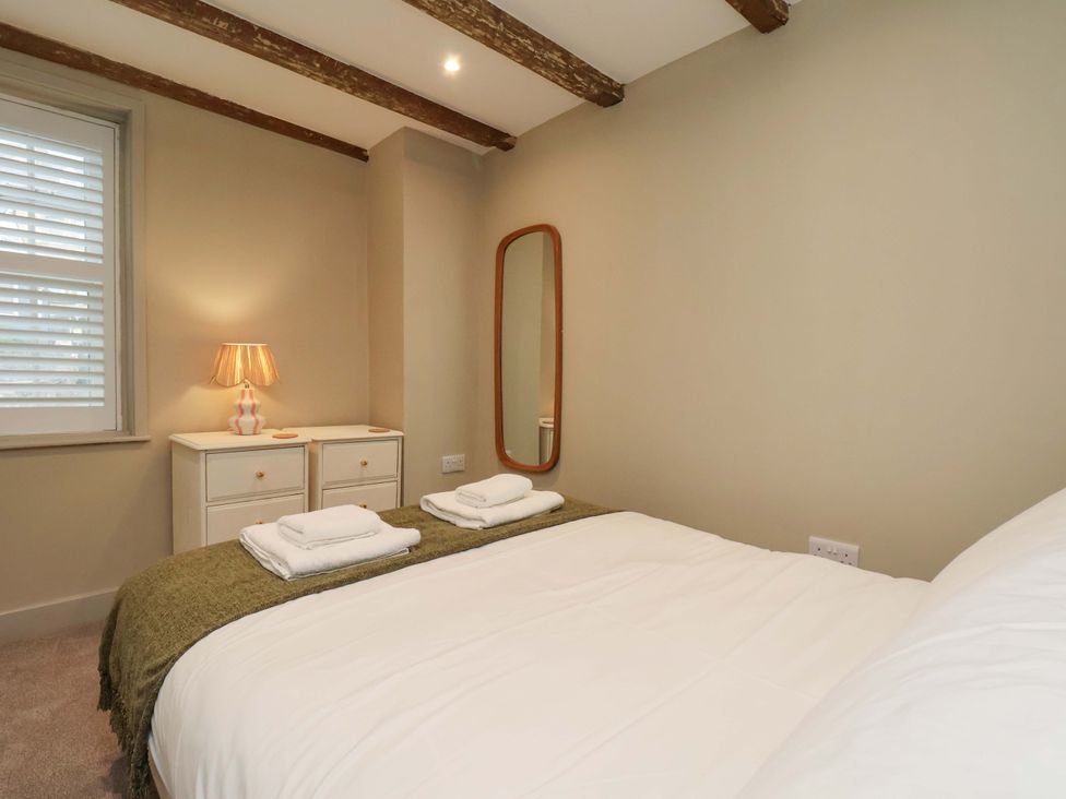 A bedroom with a bed and lamp at Wick Cottage in Whitby
