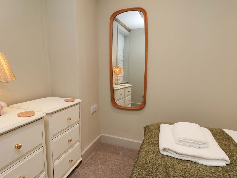 A bedroom with a bed and lamp at Wick Cottage in Whitby