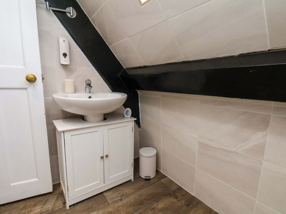 A bathroom with a sink and vanity unit at Wick Cottage in Whitby