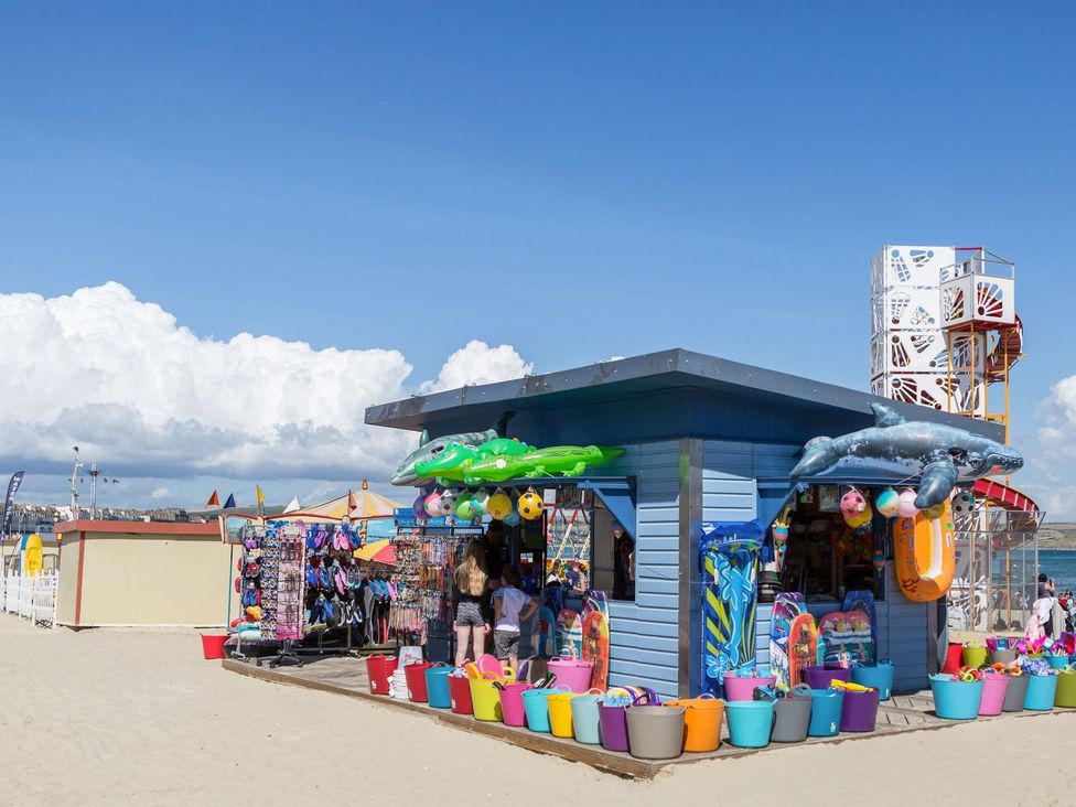 A beach hut selling toys and inflatables at Pixie Cottage in Weymouth