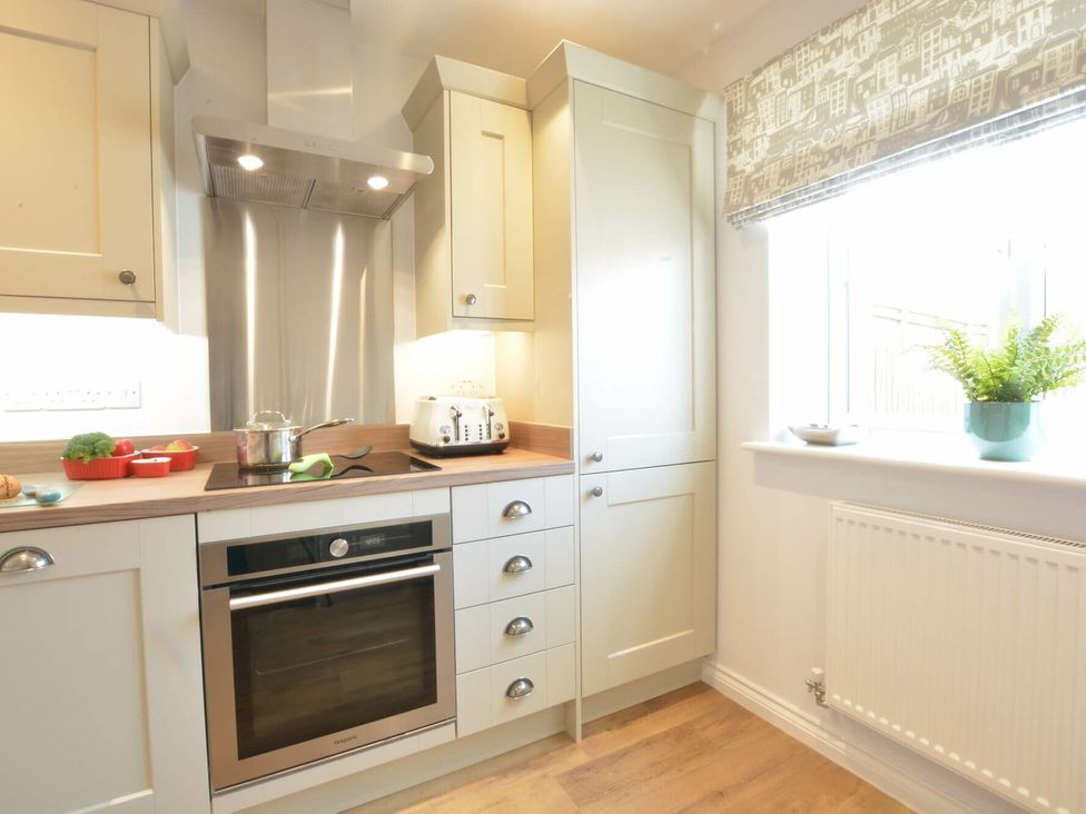 A kitchen with cabinets and a countertop at Lapwings, Aldeburgh