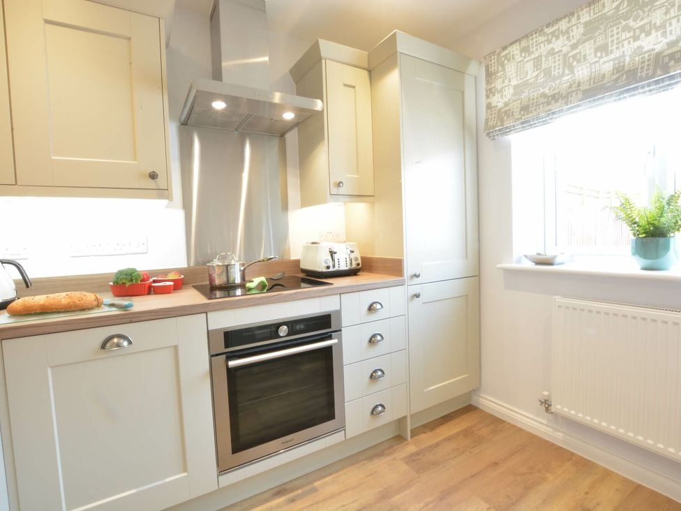 A kitchen with cabinets and appliances at Lapwings, Aldeburgh