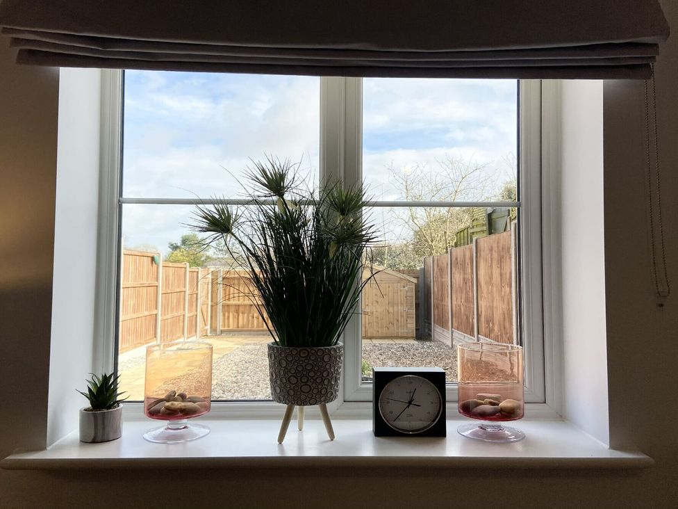 A window with plants and decor on the sill at Lapwings, Aldeburgh