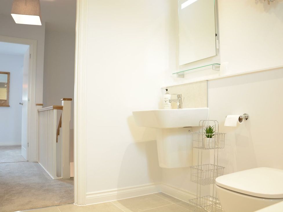 A bathroom with a sink and toilet at Lapwings, Aldeburgh