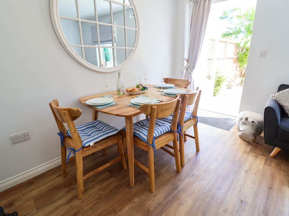 A dining room with a table and chairs at Lapwings, Aldeburgh