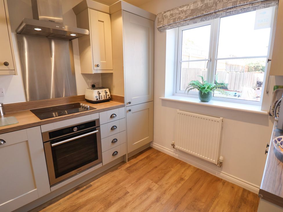 A kitchen with cabinetry and appliances at Lapwings, Aldeburgh