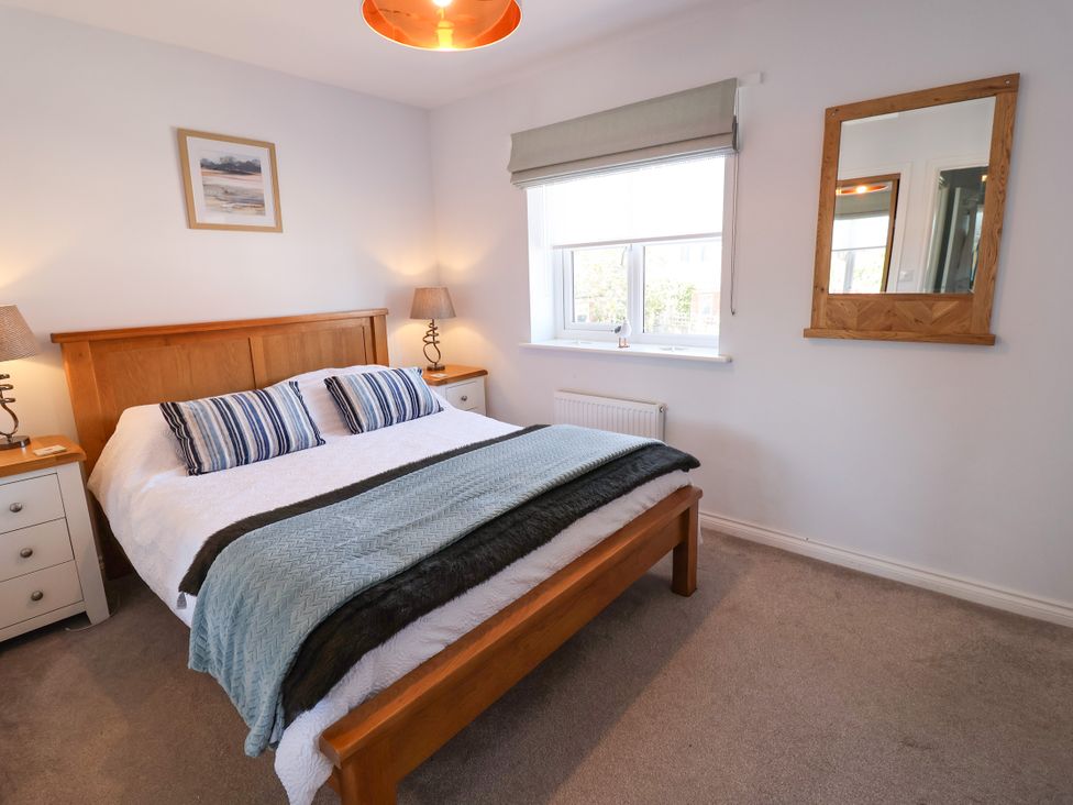 A bedroom with a double bed and bedside tables at Lapwings, Aldeburgh
