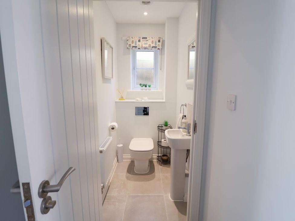 A bathroom with a toilet and sink at Lapwings, Aldeburgh