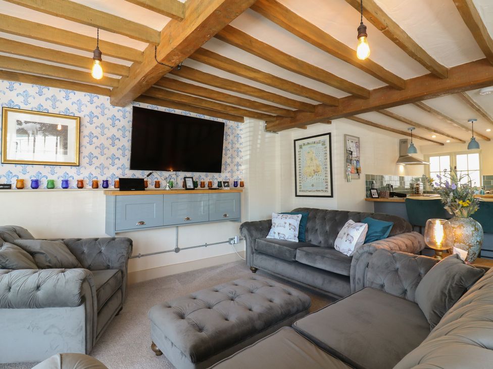 A living room with furniture and wall-mounted television at The Annex in Cavendish Near Sudbury