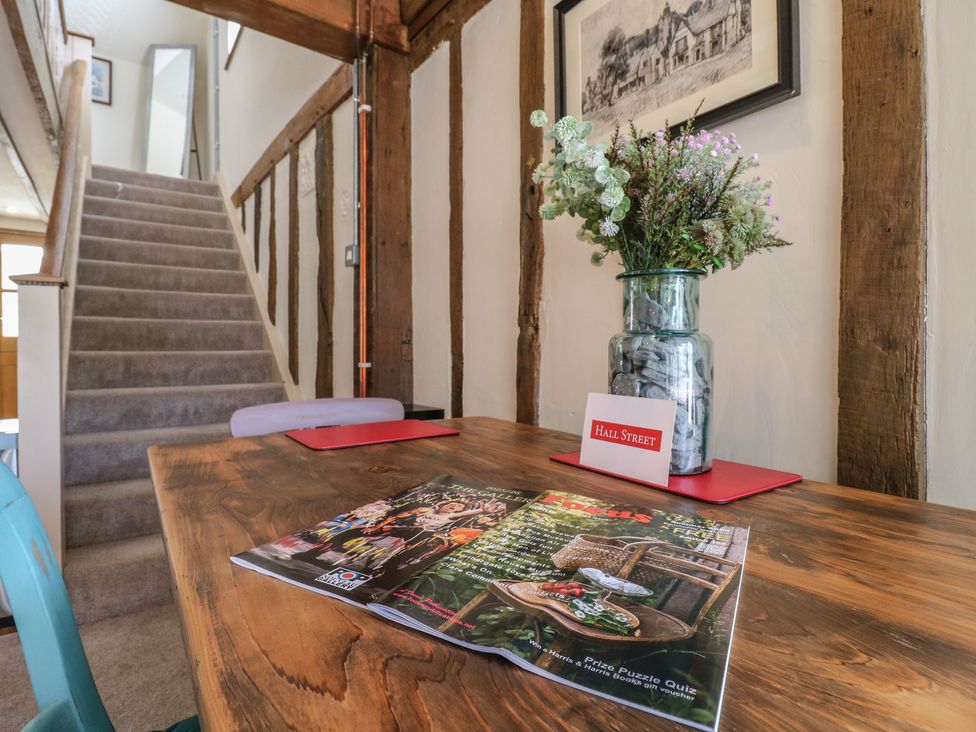 An entrance hall with a staircase and a table at The Annex in Cavendish Near Sudbury
