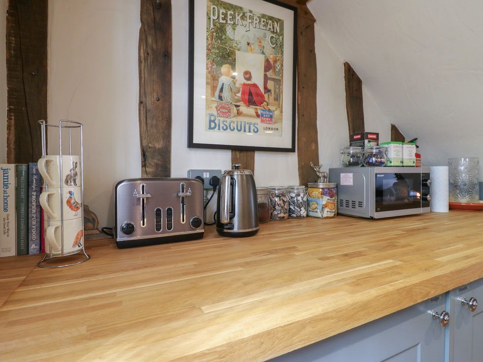 A kitchen countertop with a toaster, kettle and microwave at The Annex in Cavendish Near Sudbury