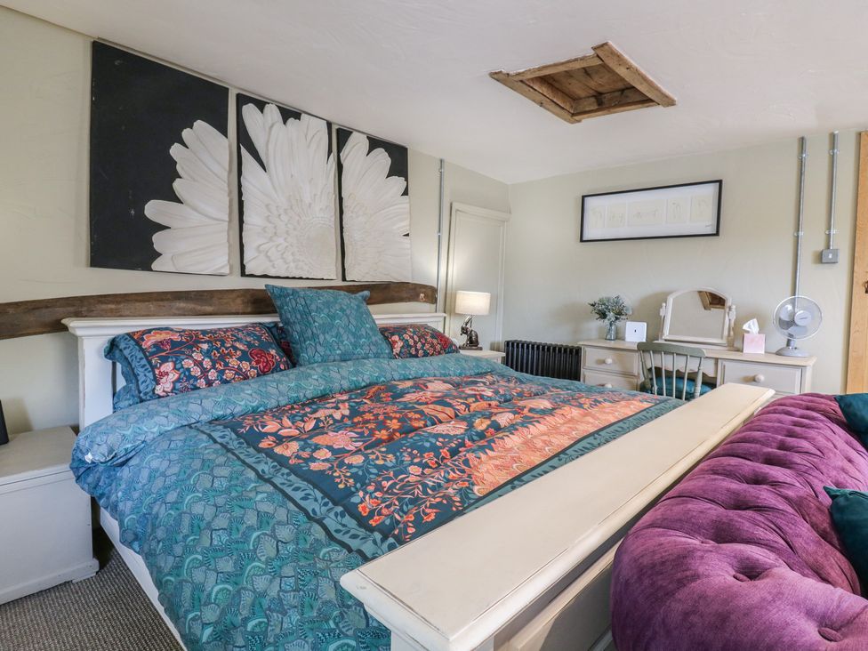 A bedroom with a bed and desk at The Annex in Cavendish Near Sudbury