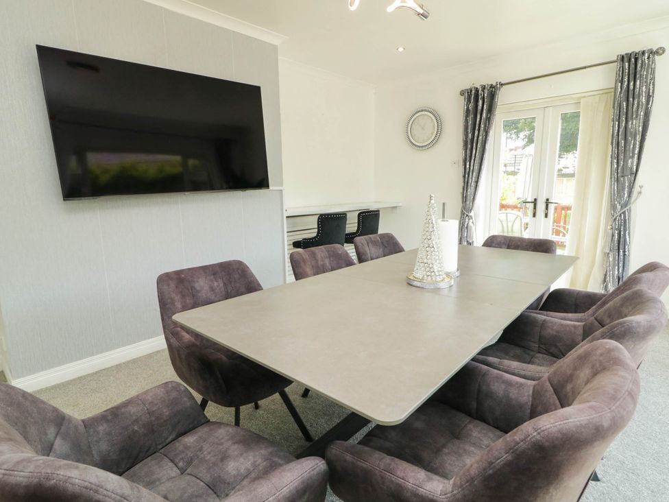A dining room with a table and chairs at 59 Nursery Avenue in Coleraine