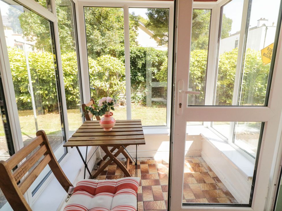 A conservatory with a table and chairs at 59 Nursery Avenue, Coleraine