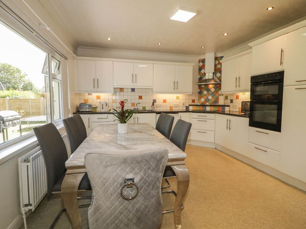 A kitchen with a table and chairs at 59 Nursery Avenue Coleraine