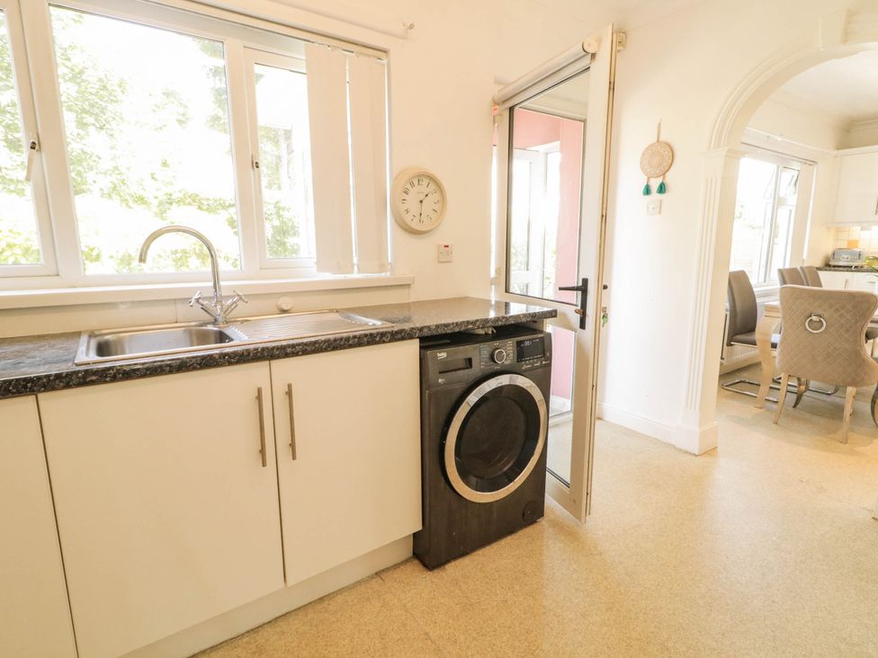 A kitchen with sink and washing machine at 59 Nursery Avenue Coleraine