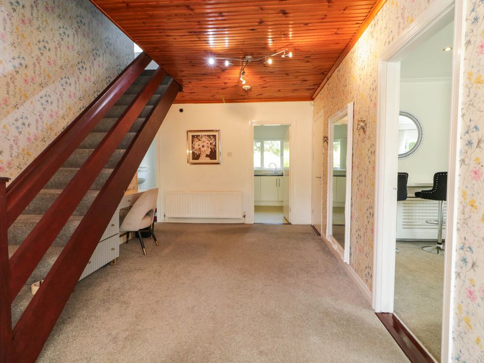 A living room with a staircase and chair at 59 Nursery Avenue in Coleraine