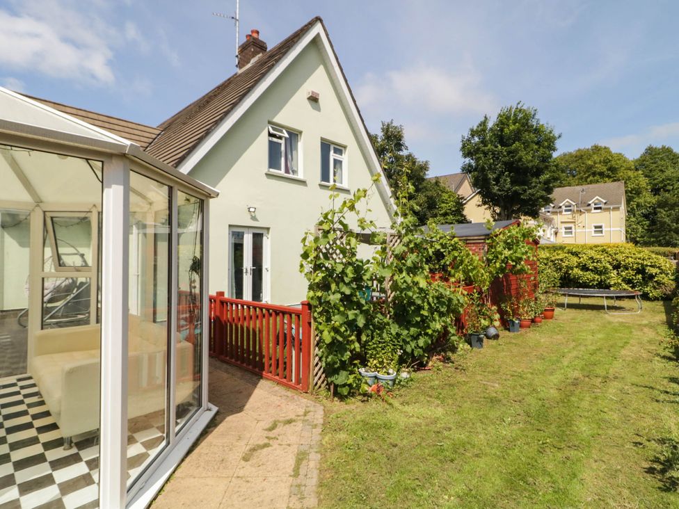 A garden with a house and conservatory at 59 Nursery Avenue Coleraine