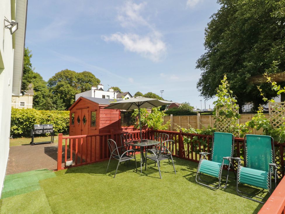 A garden with a table, chairs, and a shed at 59 Nursery Avenue, Coleraine