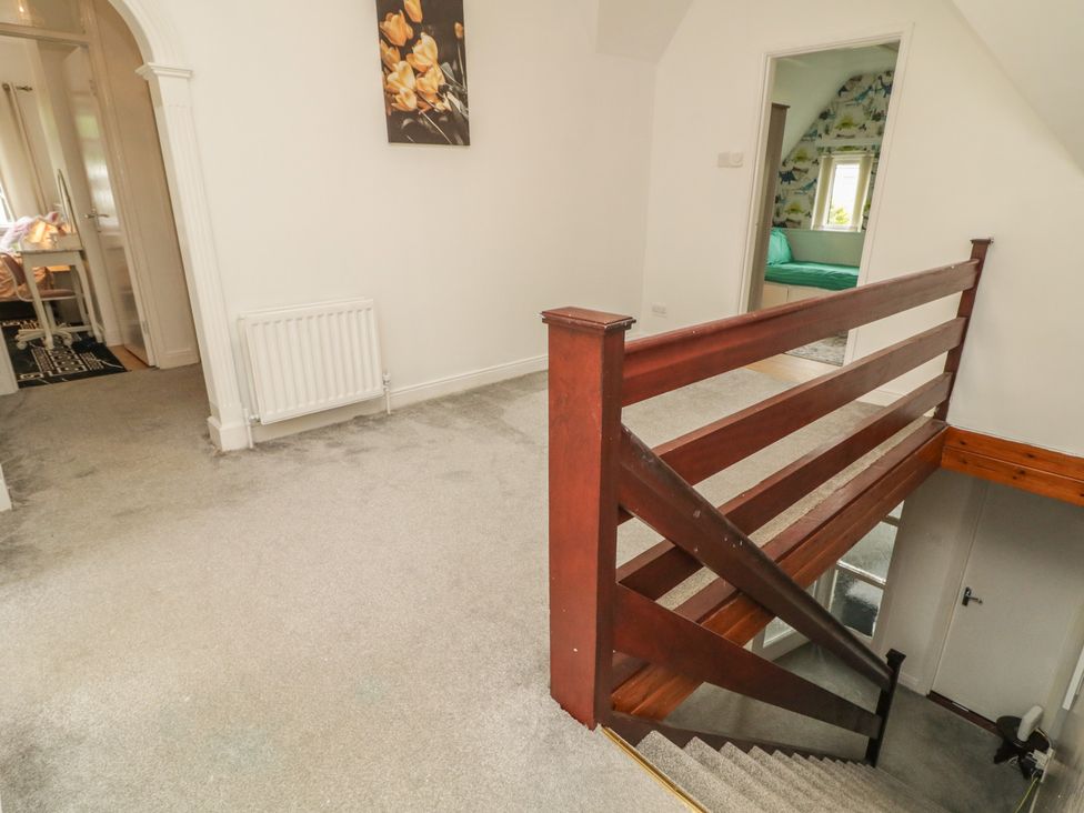 A hallway with a staircase and railing at 59 Nursery Avenue Coleraine