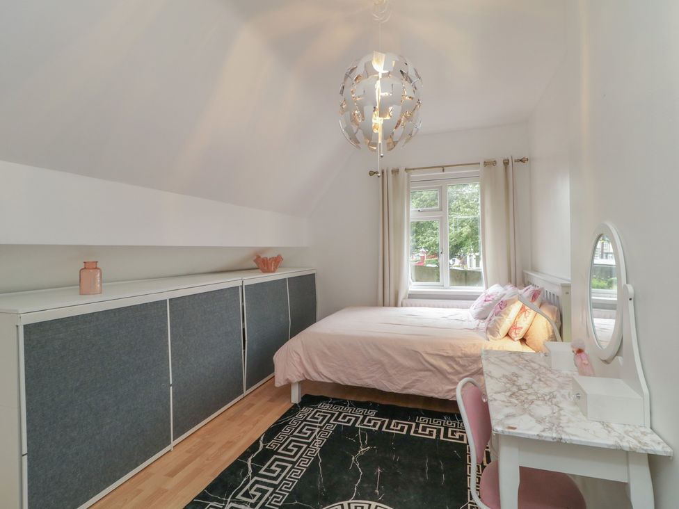 A bedroom with a bed and desk at 59 Nursery Avenue Coleraine