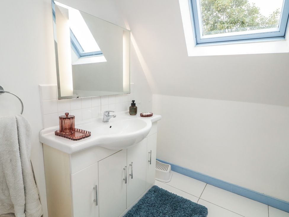 A bathroom with a sink and mirror at 59 Nursery Avenue in Coleraine